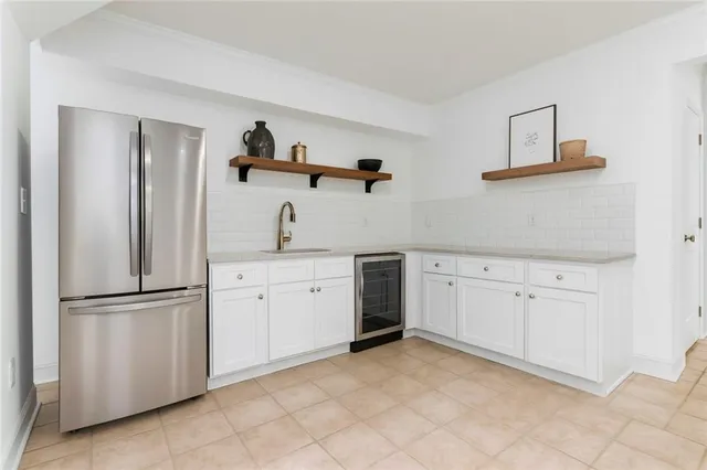 a kitchen with white cabinets and white appliances