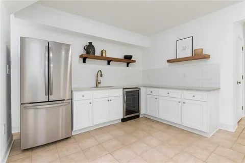 a kitchen with white cabinets and white appliances