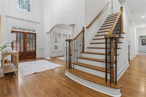 a view of entryway and hall with wooden floor