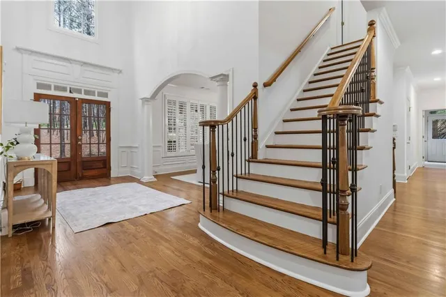 a view of entryway and hall with wooden floor