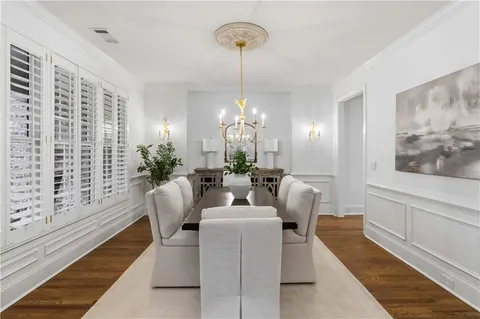 a dining room with furniture and a chandelier