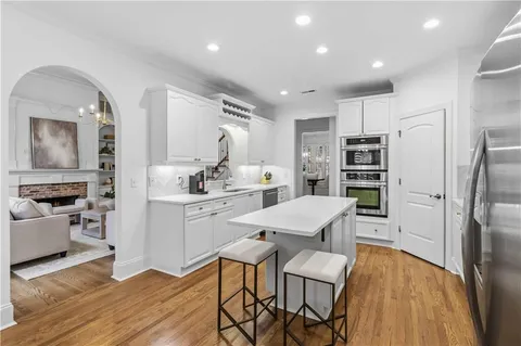 a kitchen with stainless steel appliances a refrigerator and a stove top oven