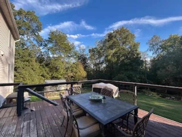 a view of a balcony with table and chairs and wooden floor