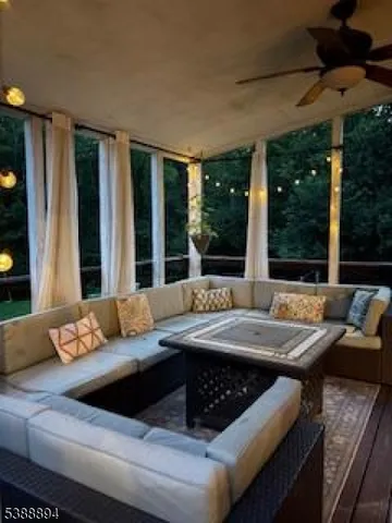 a living room with furniture and large windows