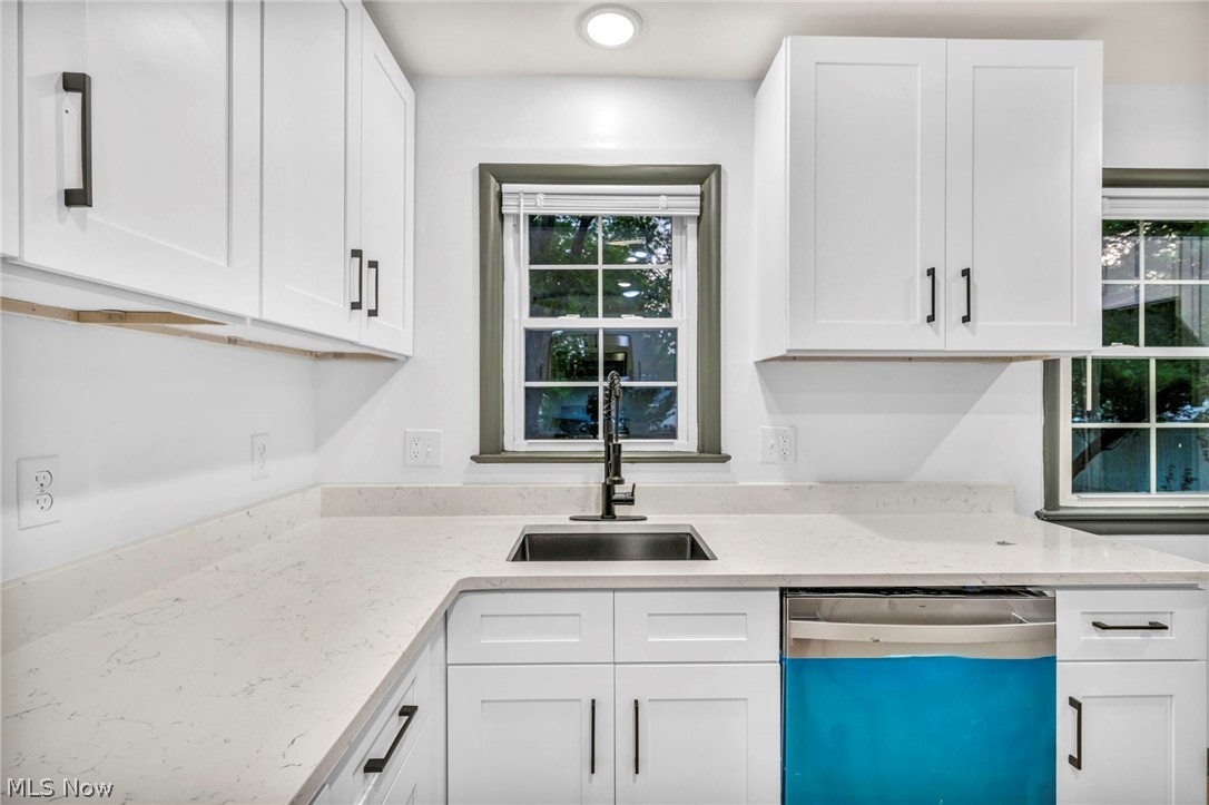 1352 Ford Road Lyndhurst, OH 44124 - Photo 32 of 48 Kitchen featuring sink, a healthy amount of sunlight, white cabinets, and stainless steel dishwasher