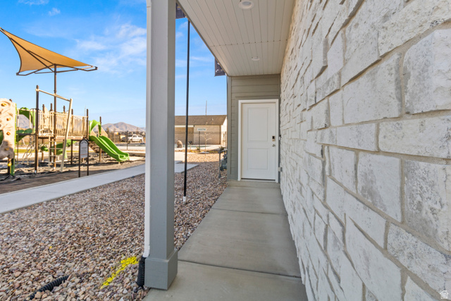 1264 West 500 South, Unit 320 Logan, UT 84321 - Photo 3 of 39 Stone brick exterior with a white entry door and covered front porch