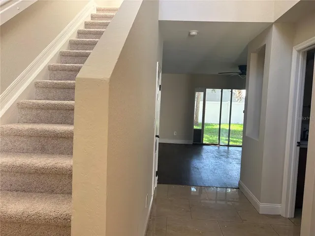 a room with a window and a ceiling fan