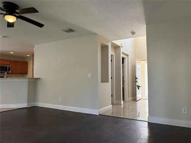 a view of a kitchen with a dishwasher cabinets and a ceiling fan
