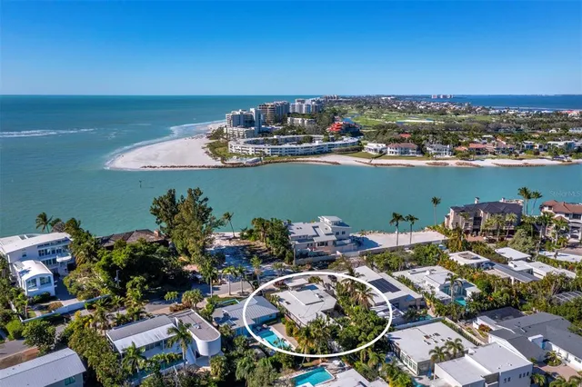 an aerial view of a house with a ocean view