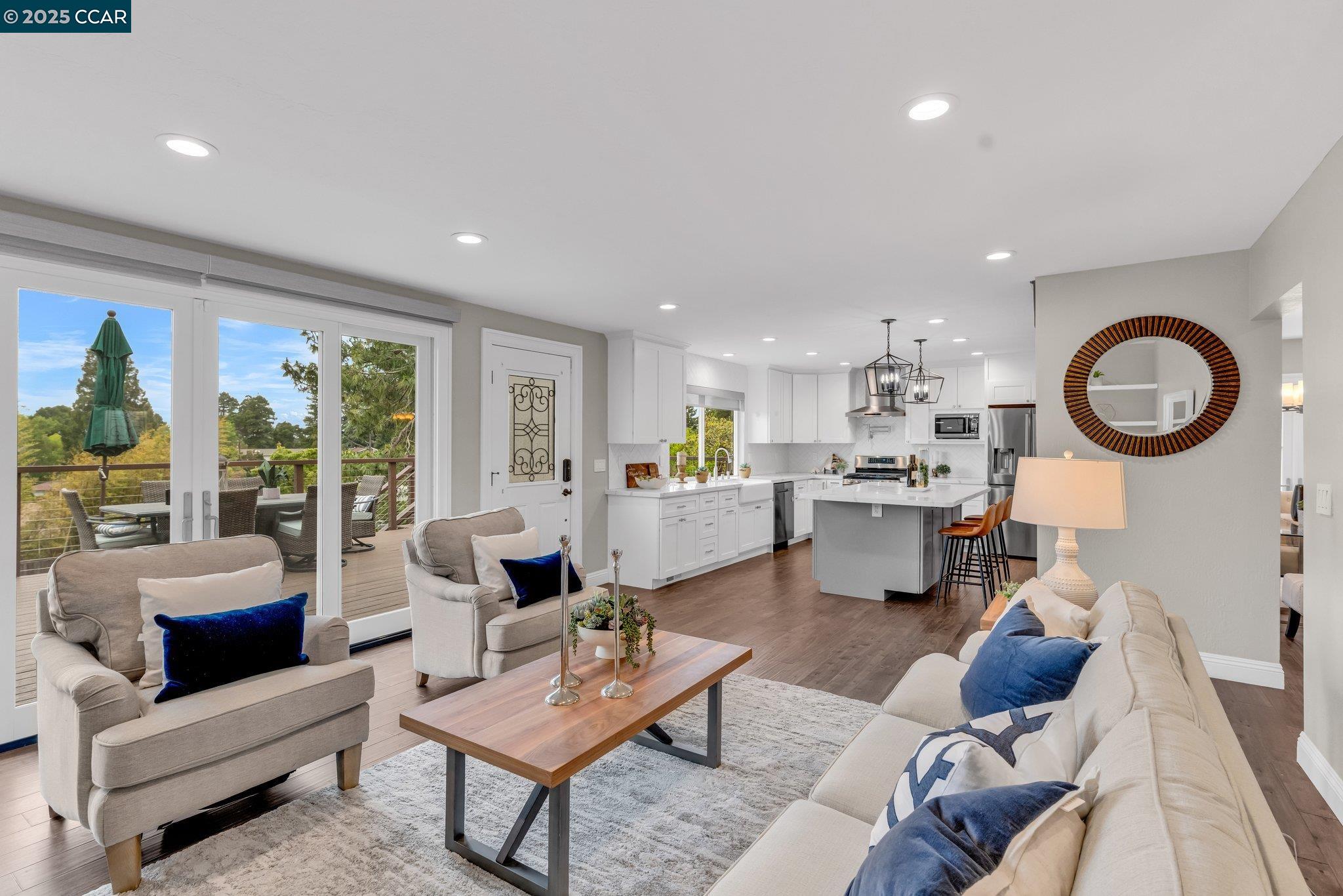 a living room with furniture a rug and a floor to ceiling window