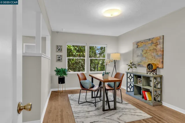 a dining room with furniture a rug and a window