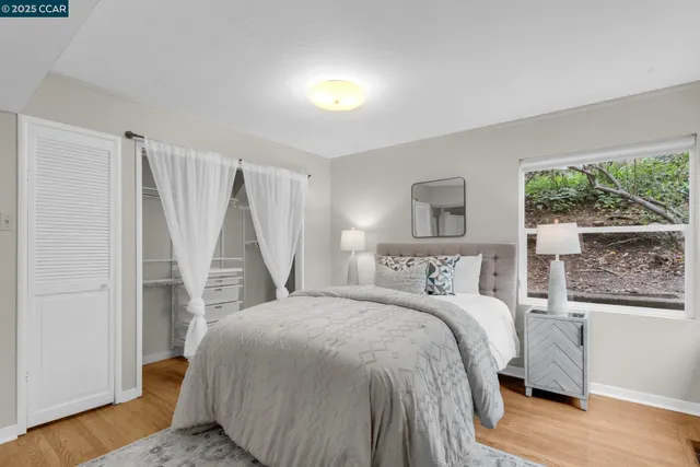 a bedroom with a bed and a large window