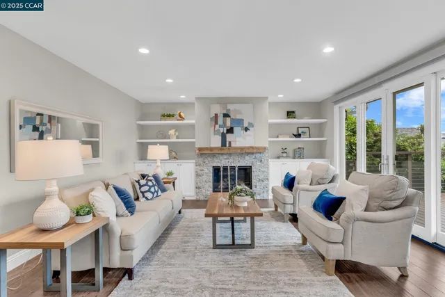 a living room with furniture fireplace and window
