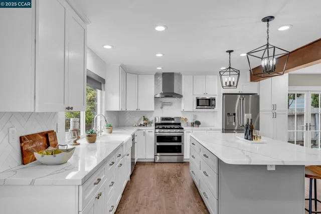 a open kitchen with stainless steel appliances granite countertop a sink and cabinets