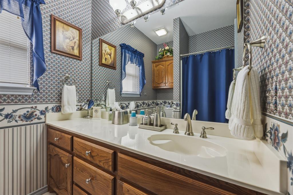 130 Blazek Road Alma, TX 75119 - Photo 21 of 34 a bathroom with a sink and a mirror