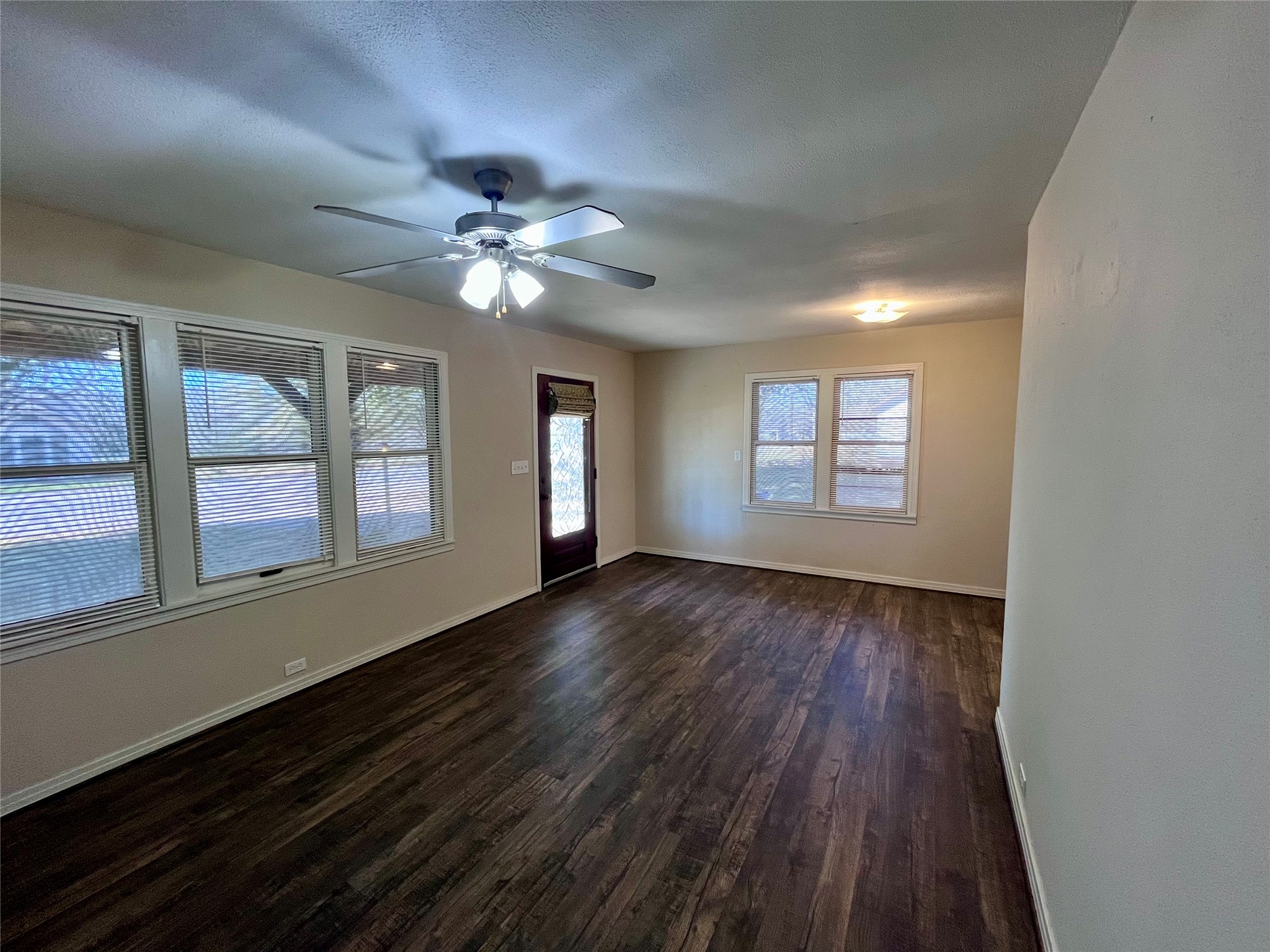 1004 North Center Street Weimar, TX 78962 - Photo 3 of 15 wooden floor in an empty room with a window