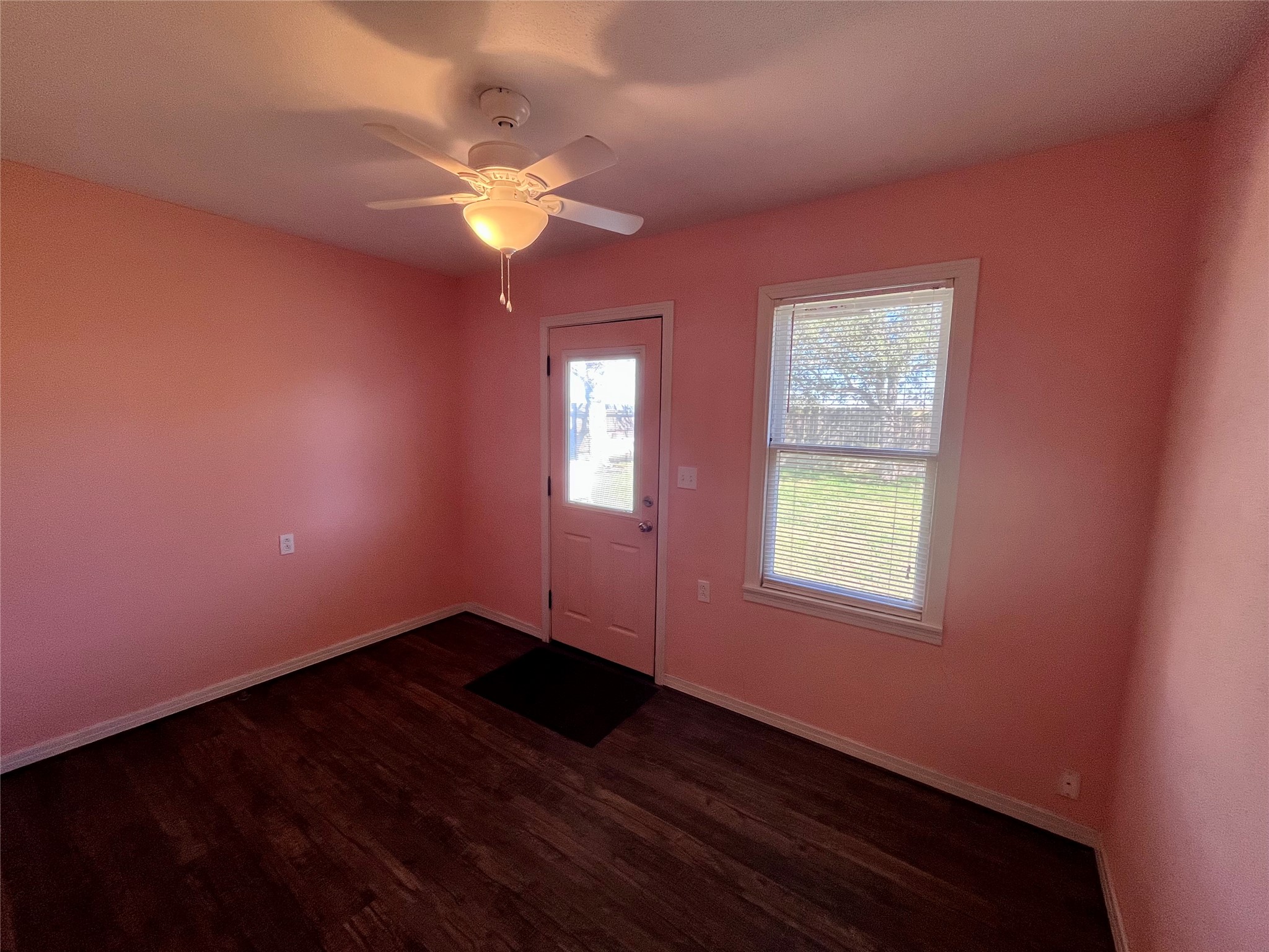 1004 North Center Street Weimar, TX 78962 - Photo 7 of 15 a view of an empty room with window and wooden floor