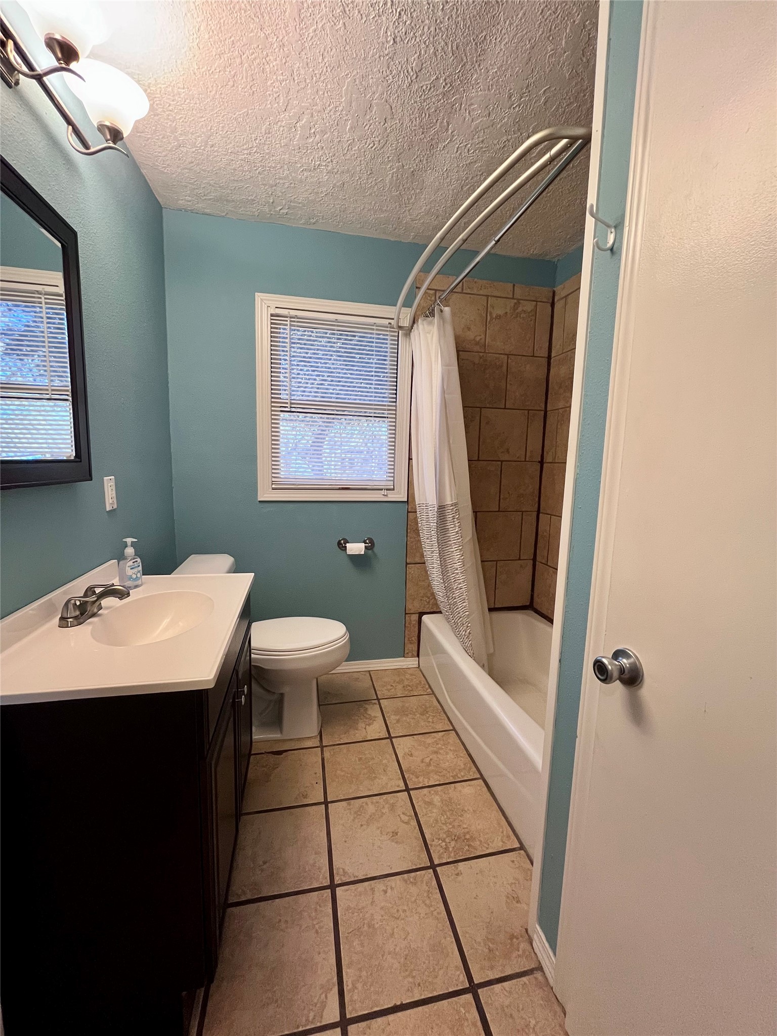 1004 North Center Street Weimar, TX 78962 - Photo 9 of 15 a bathroom with a sink a toilet and shower