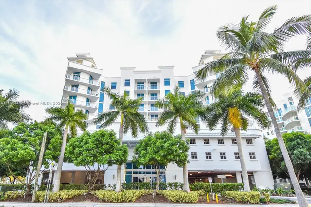 a front view of multiple houses with yard