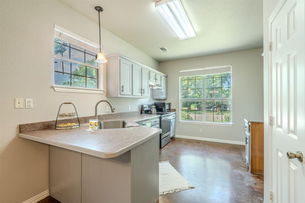 403 Summer Tree Lane Springtown, TX 76082 - Photo 4 of 19 Kitchen featuring light cabinetry, natural lighting and fresh paint