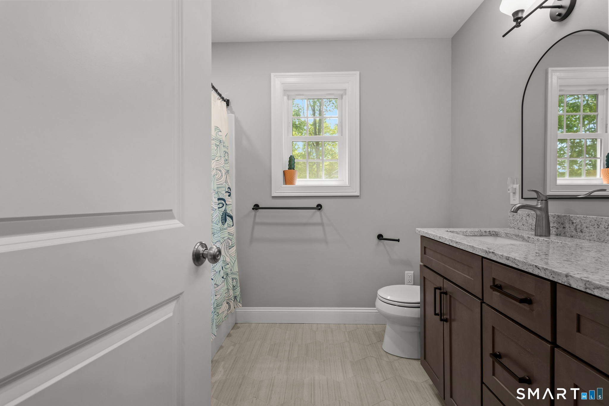 2 Martys Way Gales Ferry, CT 06335 - Photo 18 of 40 a bathroom with a granite countertop sink a toilet and a window
