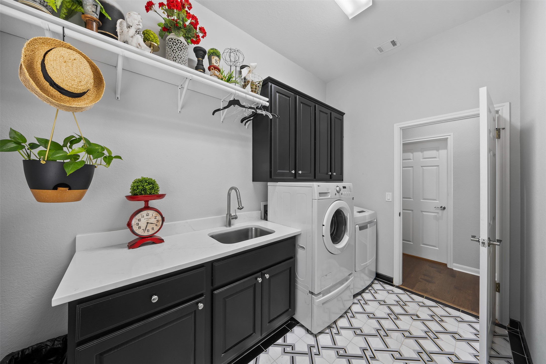 144 Stetson Trail Georgetown, TX 78633 - Photo 31 of 39 Laundry area with cabinet space, sink, and washing & dryer machines