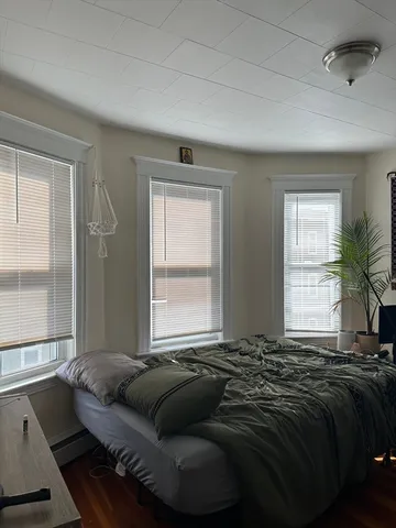 a bedroom with bed and a window