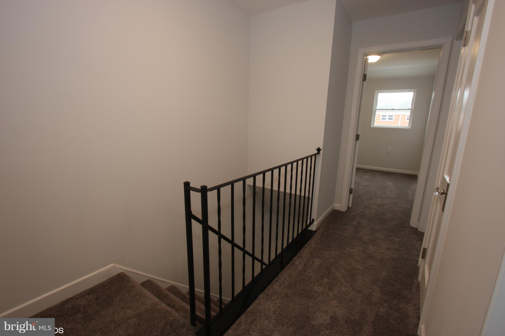 1920 Jasmine Road Baltimore, MD 21222 - Photo 13 of 40 Upstairs Hallway with Custom Iron Railing