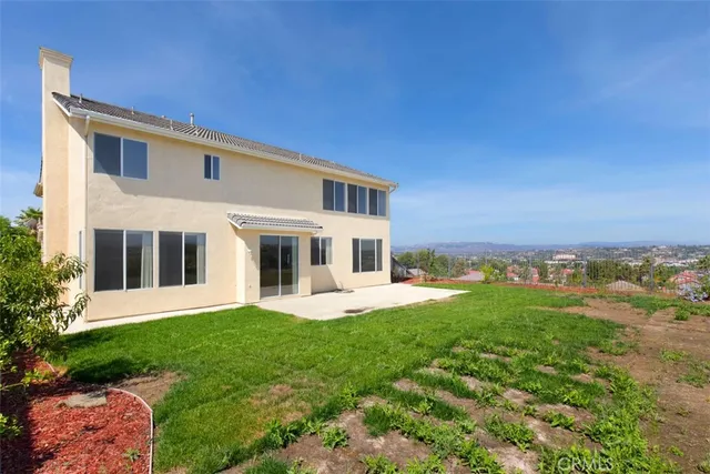 a front view of a house with a yard garage and outdoor seating