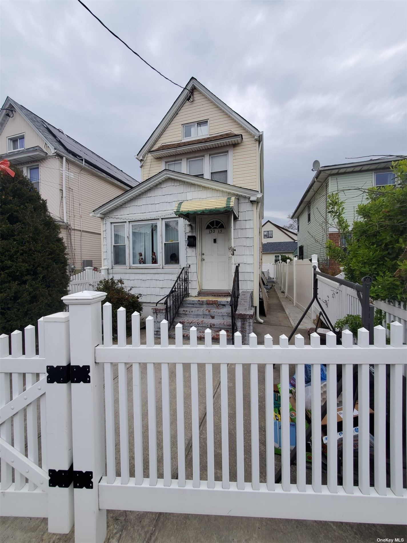 a front view of a house with fence