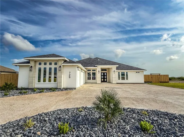 a kitchen with stainless steel appliances granite countertop a refrigerator a sink and a large window