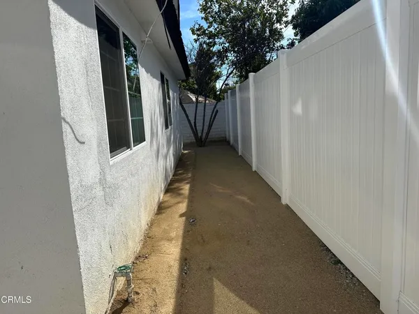a view of a pathway of a house with wooden walls