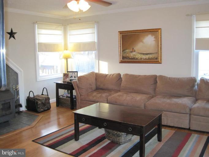 5868 Deale Churchton Road Deale, MD 20751 - Photo 20 of 28 Living room shades and woodstove convey