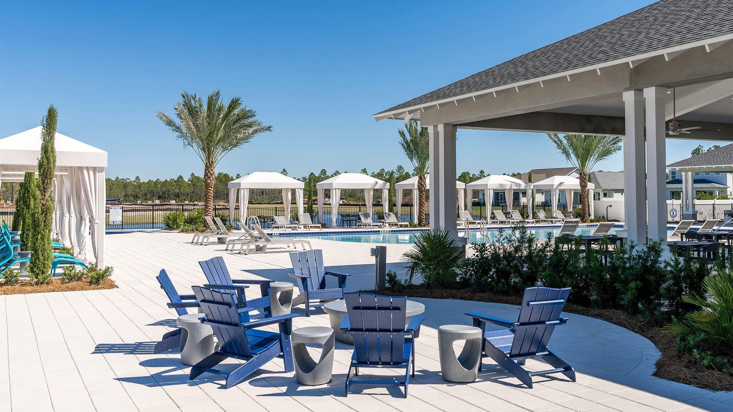 33 Dunns Cir Inlet Beach Inlet Beach, FL 32461 - Photo 62 of 82 a view of a patio with table and chairs potted plants and floor to ceiling window