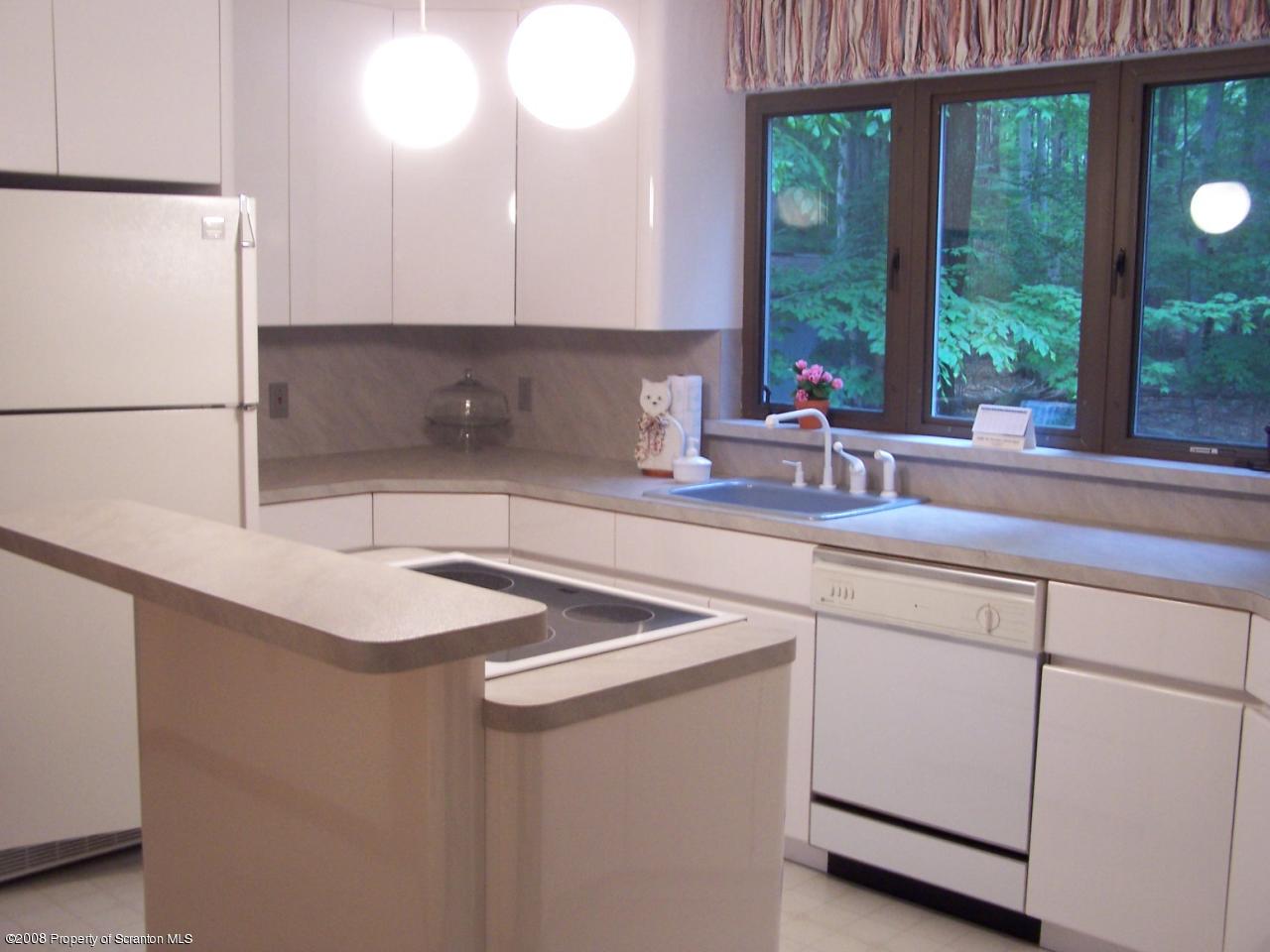 3284 Northgate Road Lake Ariel, PA 18436 - Photo 3 of 14 a kitchen with stainless steel appliances granite countertop a sink a refrigerator and a granite counter tops with large windows