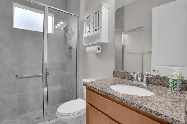 a kitchen with stainless steel appliances granite countertop a sink refrigerator and cabinets