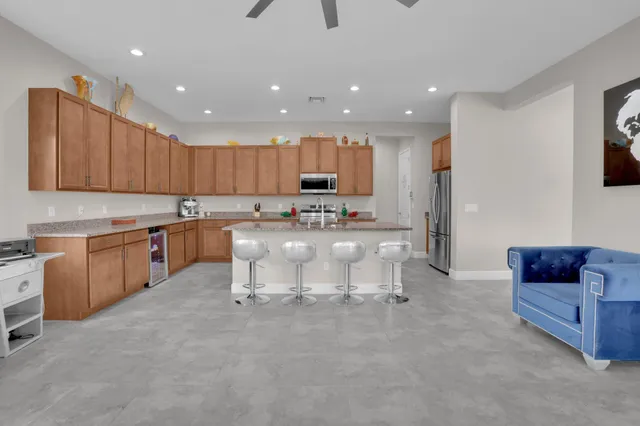 a bathroom with a granite countertop sink a light fixture and a mirror