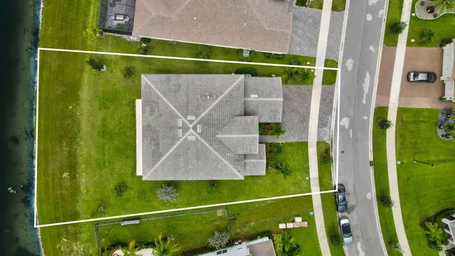 an aerial view of a house with a swimming pool yard and outdoor seating