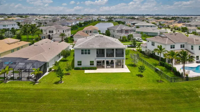 an aerial view of a house with a big yard