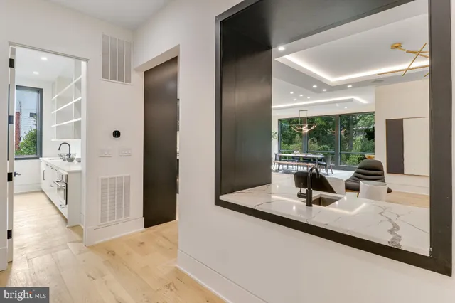 a bathroom with a sink vanity mirror and next to a window