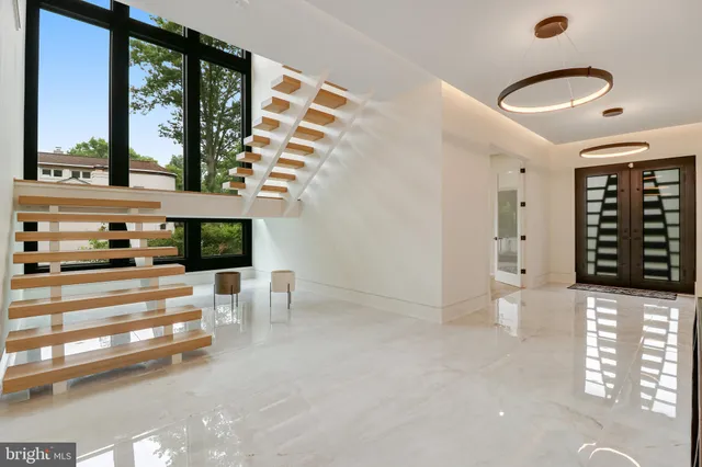 a living room with furniture kitchen view and a large window