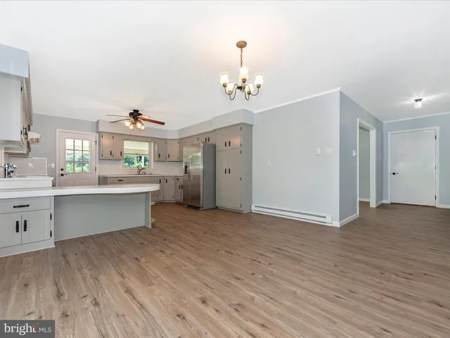 a kitchen with a sink stainless steel appliances and cabinets