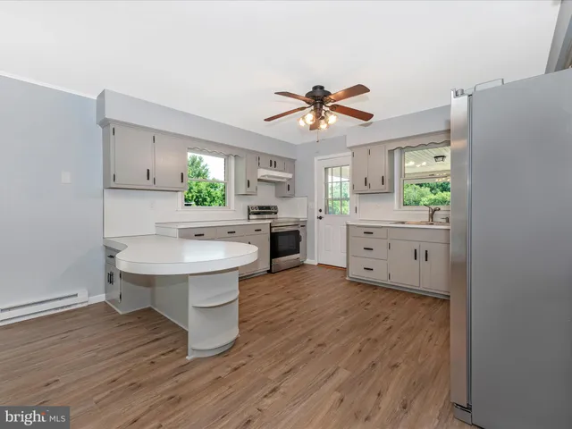 a dining room with furniture and wooden floor