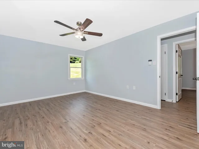 wooden floor in an empty room with a window