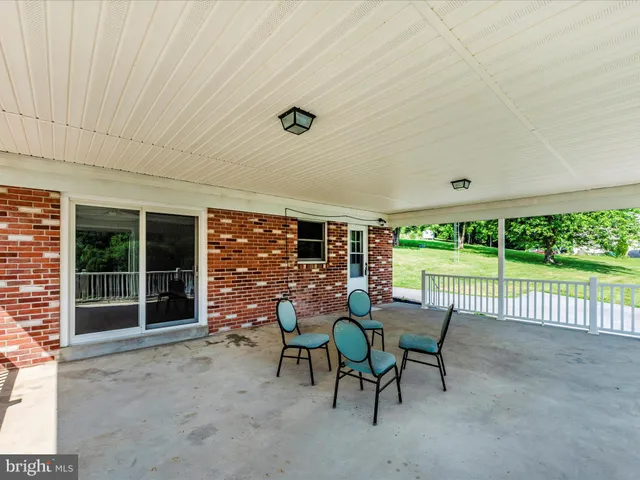 a view of a wooden deck next to a yard