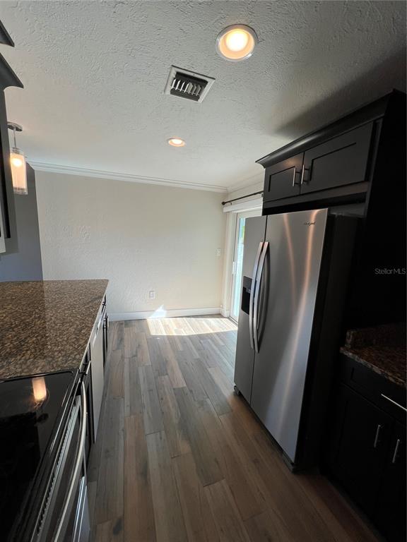 511 West Retta Esplanade Punta Gorda, FL 33950 - Photo 10 of 19 a view of a refrigerator a kitchen counter space and wooden floor