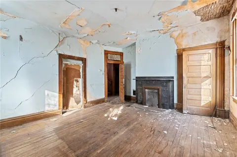 a view of a livingroom with a fireplace and window