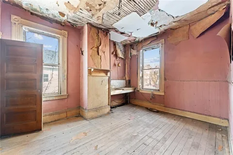 a kitchen with refrigerator and cabinets