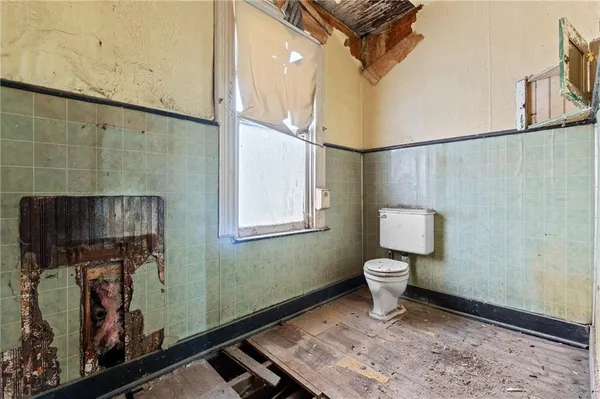 a view of a livingroom with wooden floor and a window