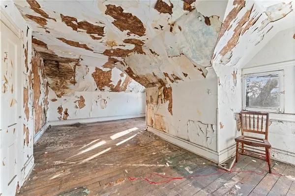 a front view of a building with large trees